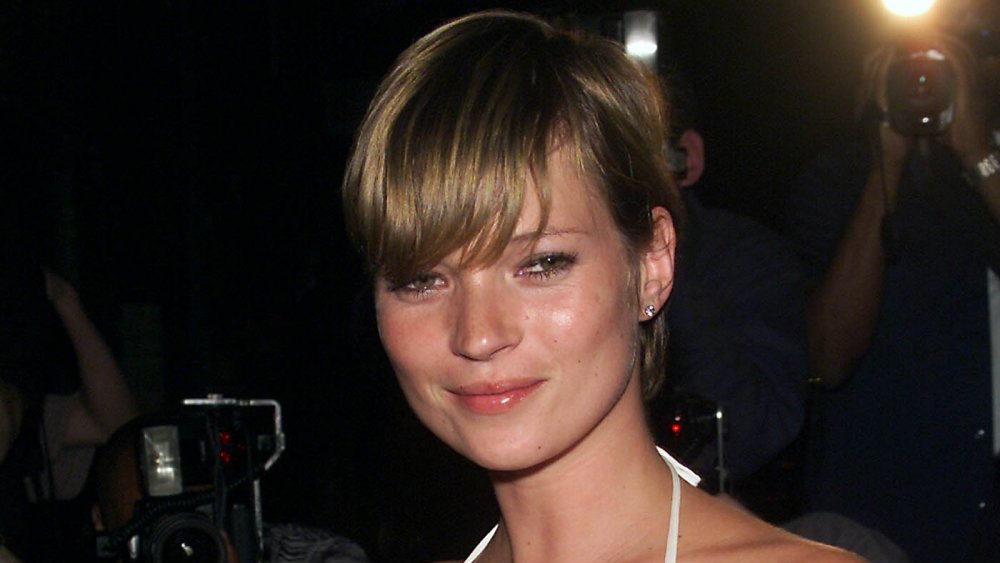 Young Kate Moss with hair pulled back and bangs