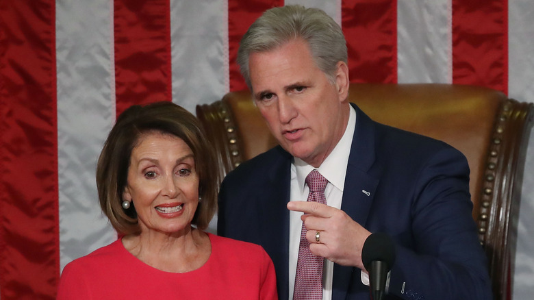 Nancy Pelosi standing near Kevin McCarthy