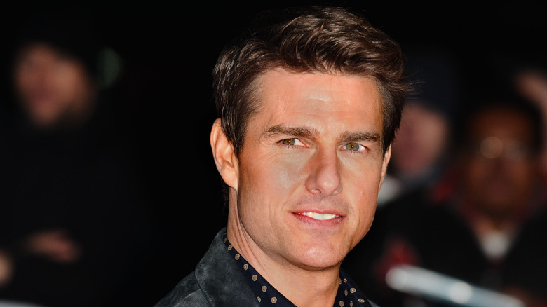 Tom Cruise looking sideways smiling