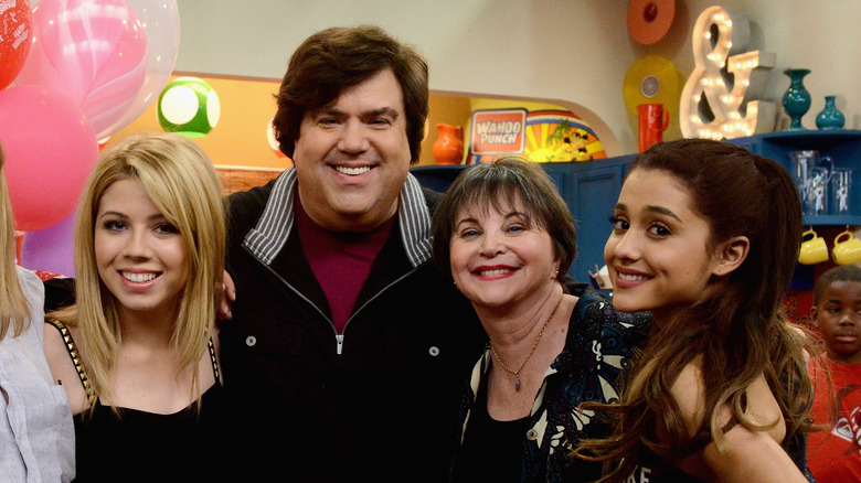 Ariana Grande and Dan Schneider smile for a photo on set