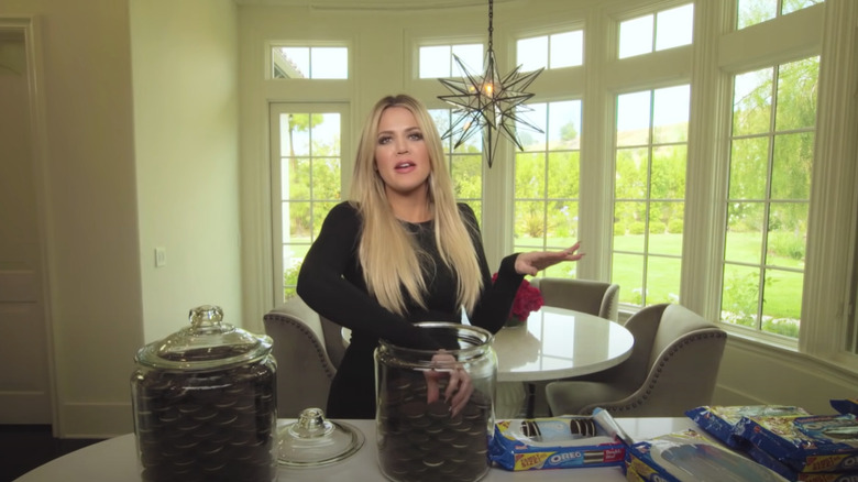 Khloé Kardashian arranging cookies in jar