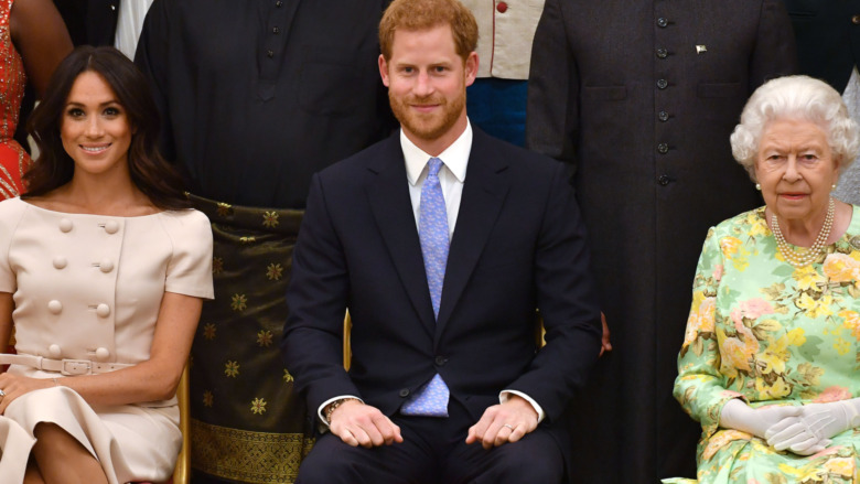 Duchess of Sussex, Prince Harry, Duke of Sussex and Queen Elizabeth II at the Queen's Young Leaders Awards Ceremony at Buckingham Palace on June 26, 2018