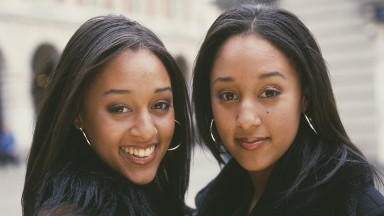 Tia and Tamera Mowry posing in the 90s