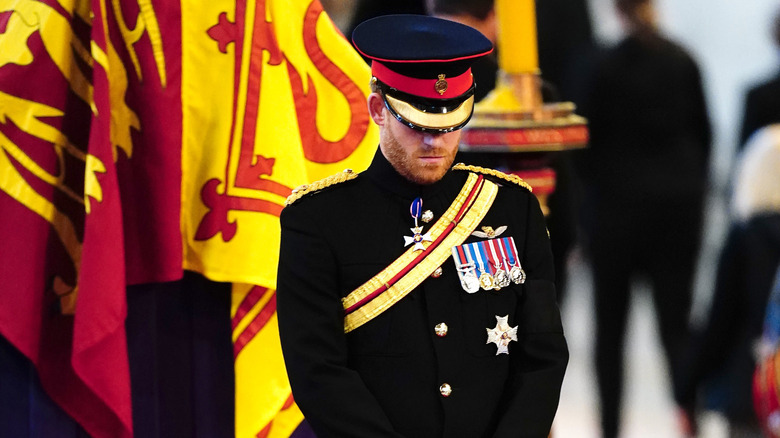 Prince Harry bowing head in uniform