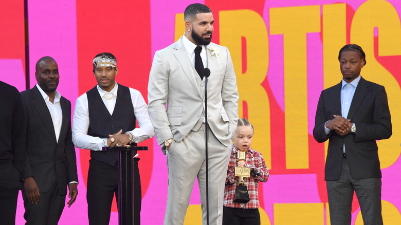 Drake with Adonis onstage 