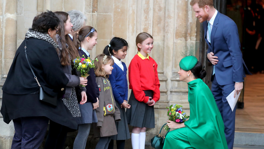 Meghan Markle and Prince Harry greeting children