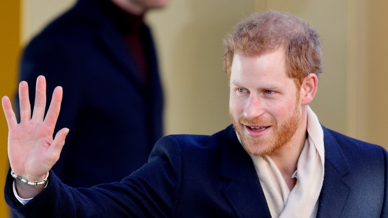 Prince Harry smiling and waving