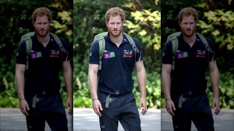 Prince Harry outside wearing a backpack