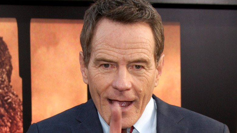 Bryan Cranston shakes a finger at a photographer