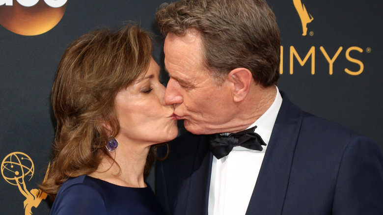 Robin Dearden and Bryan Cranston kiss on the Emmy's red carpet