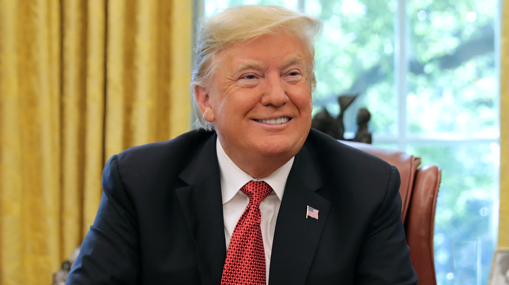 Donald Trump sitting and smiling