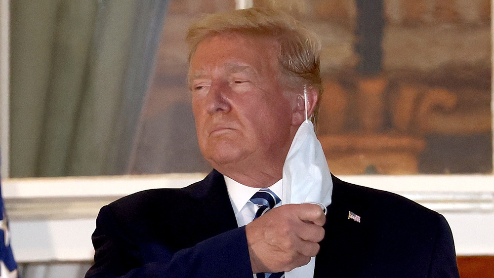 Donald Trump taking off face mask