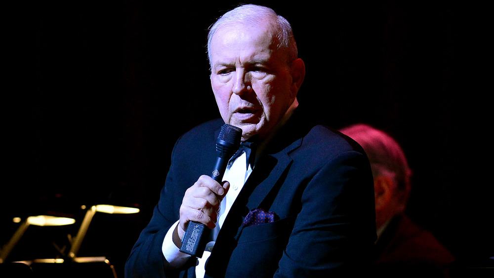 Frank Sinatra Jr. holding a microphone