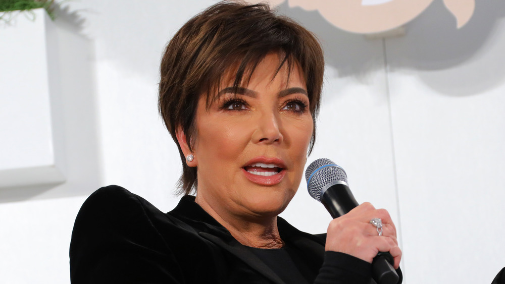 Kris Jenner holding a microphone