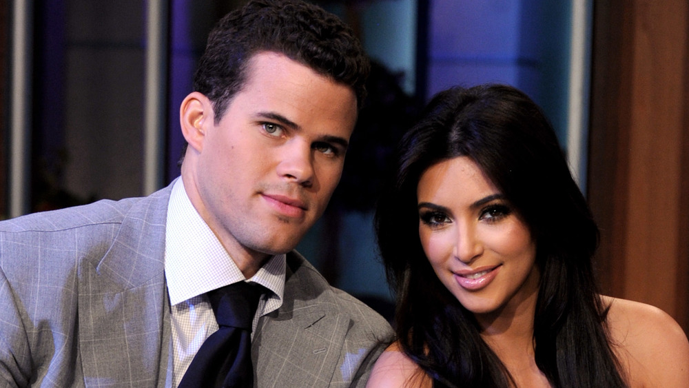 Kris Humphries and Kim Kardashian leaning in close to one another 