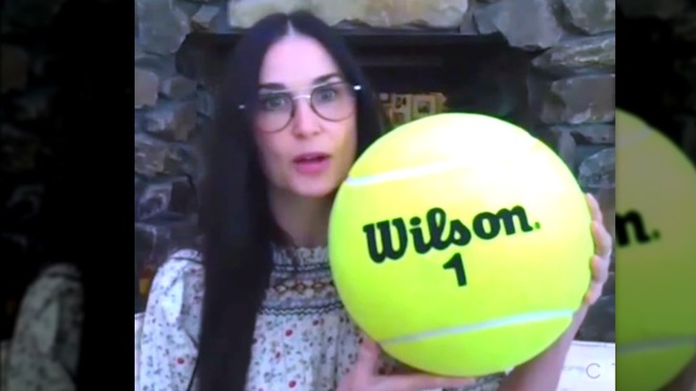 Demi Moore holding giant tennis ball