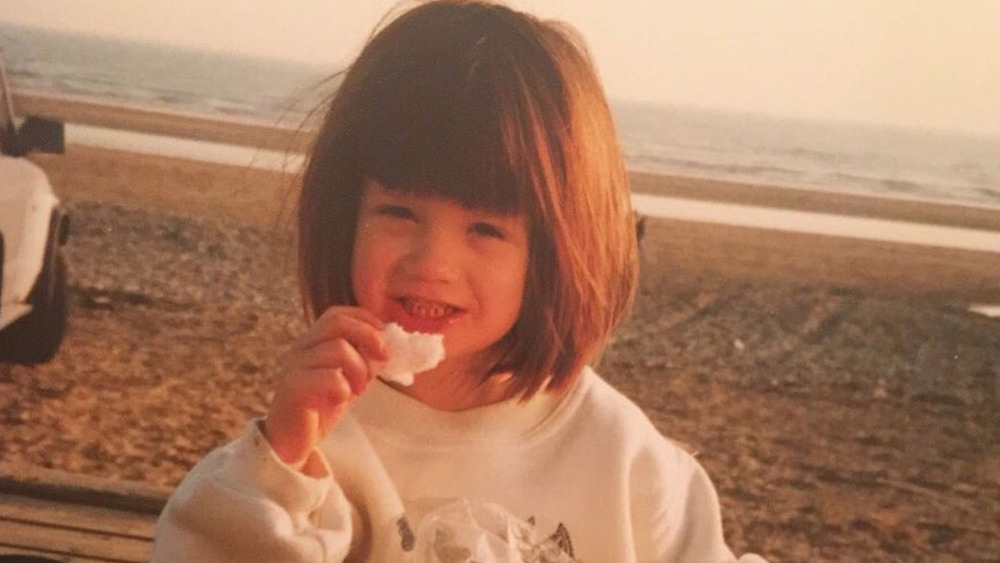 Bonnie Wright on a beach as a child