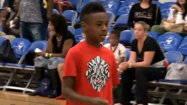 Young Bronny James in a red t-shirt