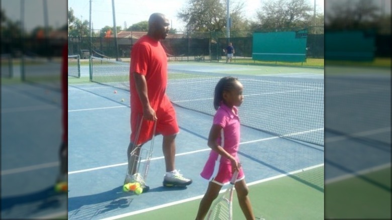 Coco and Corey Gauff walking on tennis court