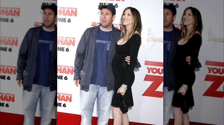 Adam Sandler posing with his arm around Jackie Sandler