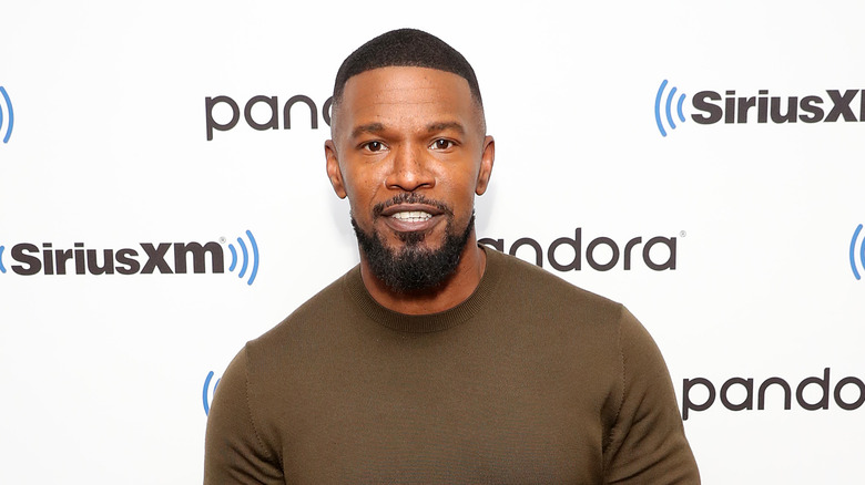 Jamie Foxx posing in brown shirt