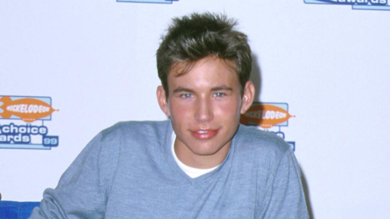 Jonathan Taylor Thomas on red carpet in 1999