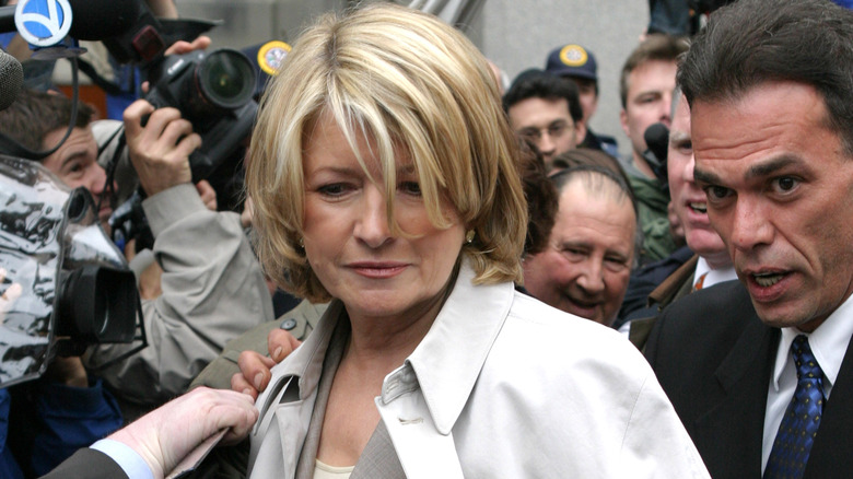 Martha Stewart walking through a crowd of cameras