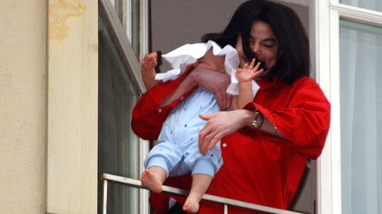 Michael Jackson dangling baby over balcony