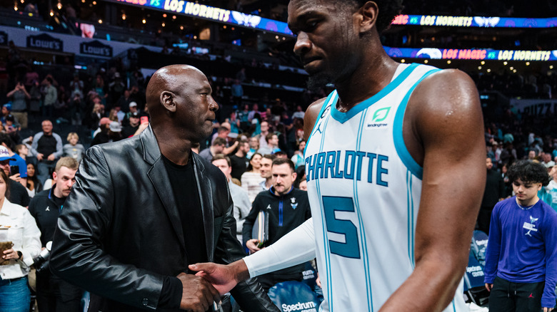 Michael Jordan shaking hands with player at Charlotte Hornets game