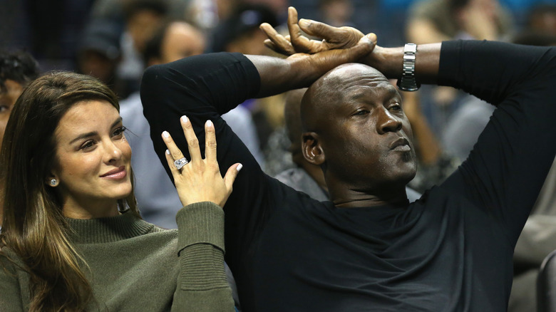 Yvette Prieto and Michael Jordan watch an NBA game together