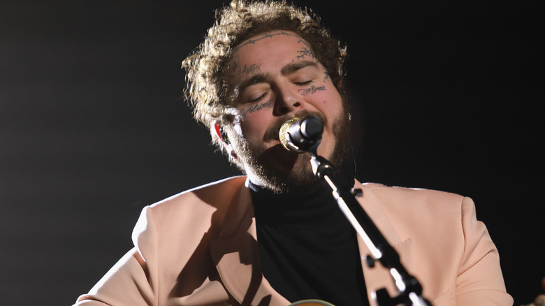 Post Malone singing into a microphone