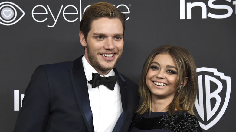 Dominic Sherwood and Sarah Hyland grinning