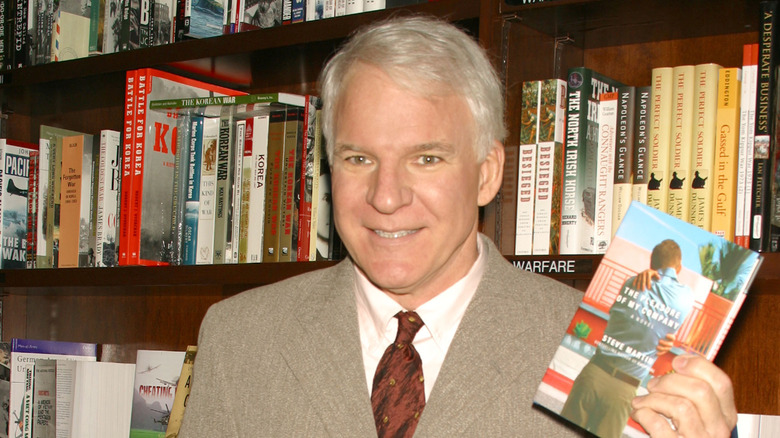 Steve Martin posing with his book