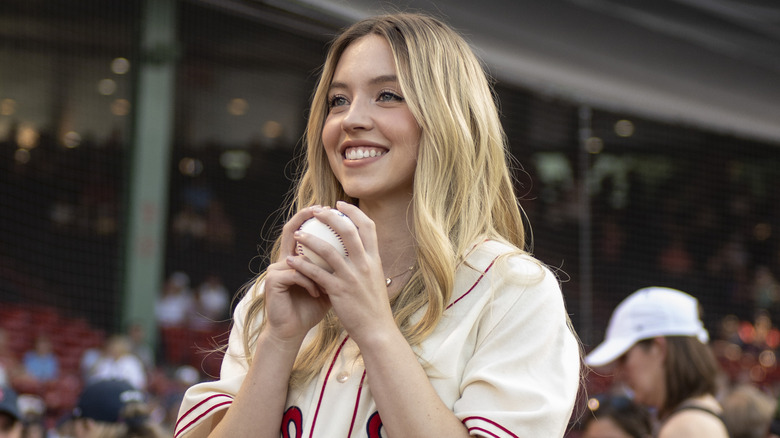 Sydney Sweeney smiling with baseball