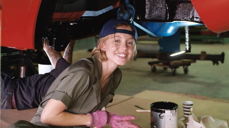 Sydney Sweeney smiling in garage