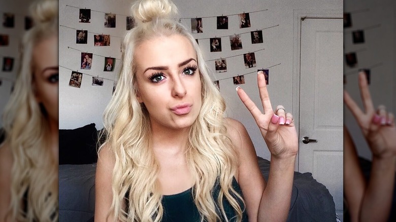 Tana Mongeau posing in her bedroom