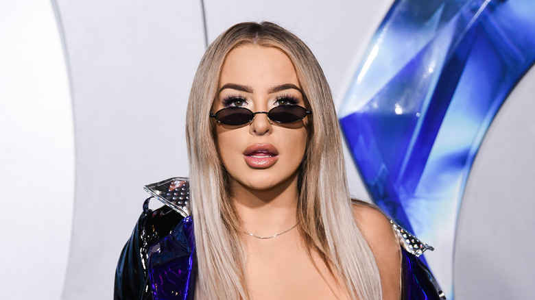 Tana Mongeau posing with glasses