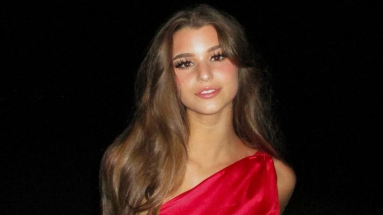 Brooke Monk posing in a red dress