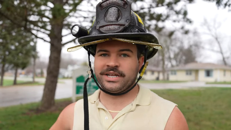 Frankie Lapenna wears firefighter helmet