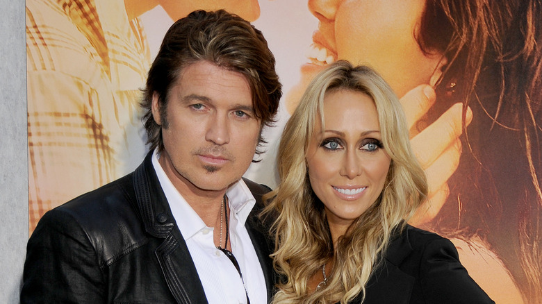 Billy Ray and Tish posing at a movie premiere