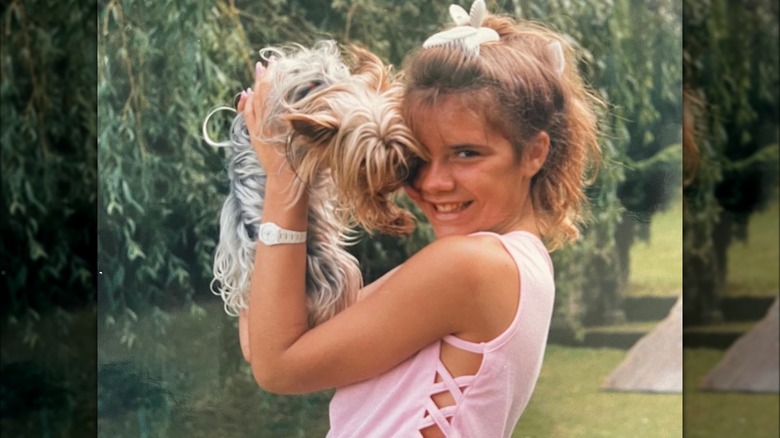 Teenage Victoria Beckham holding dog