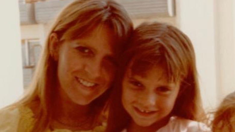 Young Victoria Beckham with her mom