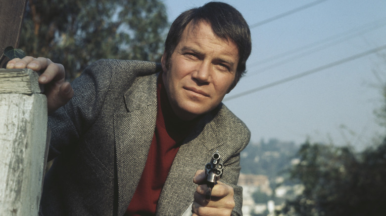 William Shatner pointing a gun