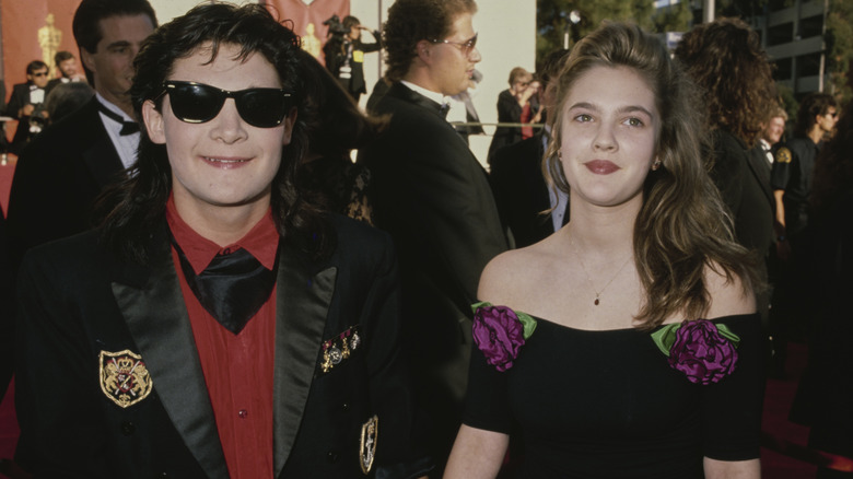 Corey Feldman and Drew Barrymore smiling together