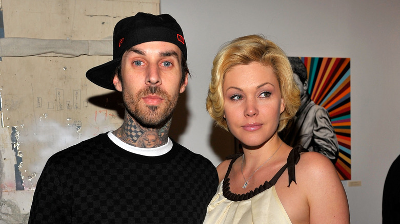 Travis Barker and Shanna Moakler posing at event