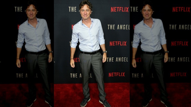 Zach Braff blue shirt grey pants