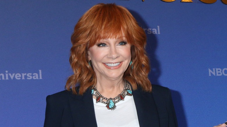 Reba McEntire grinning with wavy hair