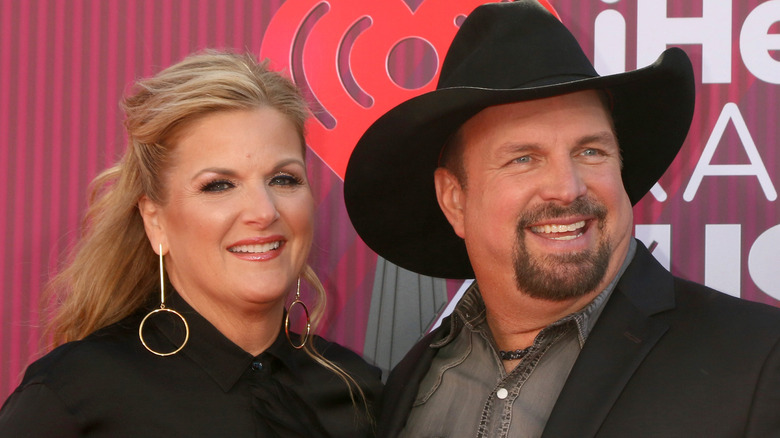 Trisha Yearwood and Garth Brooks posing