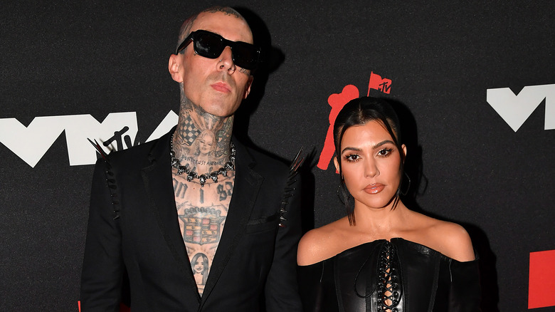 Kourtney Kardashian and Travis Barker posing on the red carpet