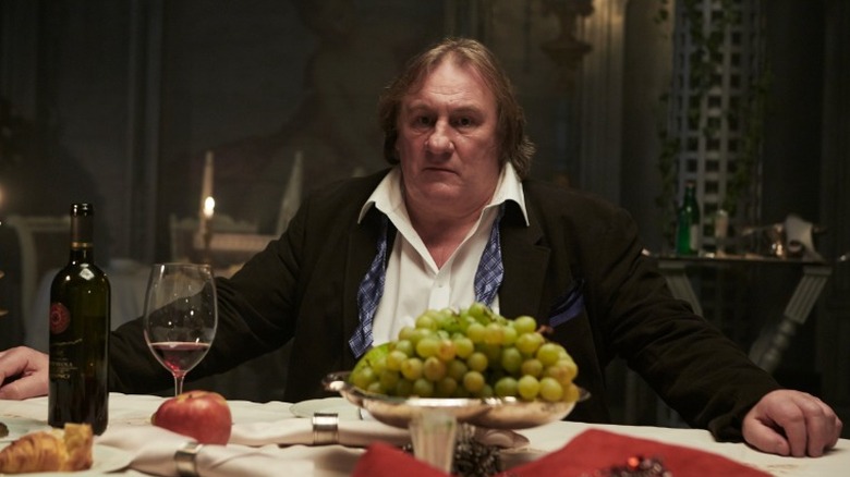 Gerard Depardieu sitting at table 